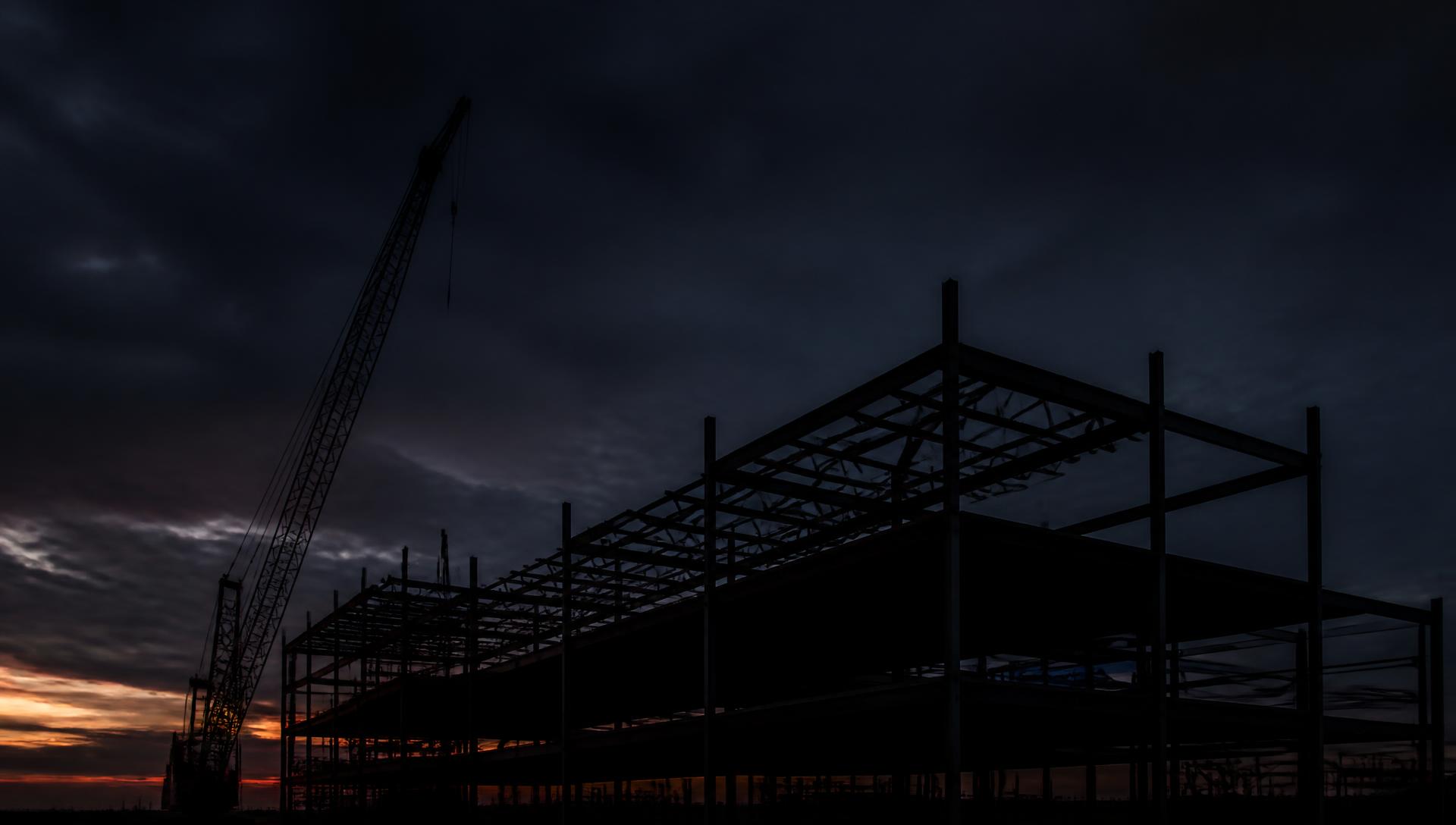 Steel structural frame of a commercial building at dusk